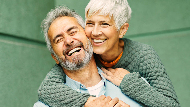 A couple of best-agers close and loughing together